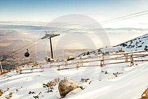 Winter landscape on mountain ski resort with cabin lifts and sunny sky