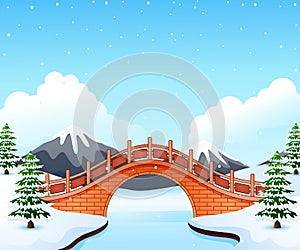 Winter landscape with mountain and small stone bridge over river