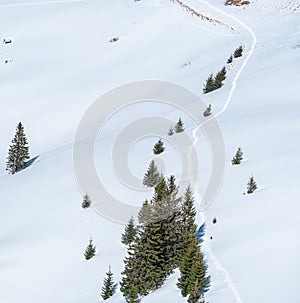 Winter landscape in the mountains with a footpath made through the fresh snow