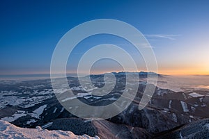 Winter landscape in mountains illuminated at sunrise and in background High Tatras, Slovakia Velky Choc