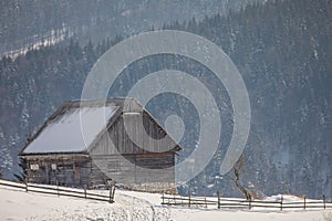 Winter landscape with an old house in a village