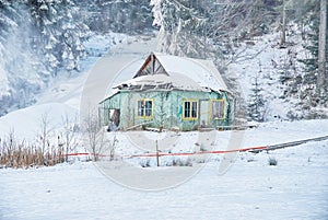 Winter landscape. Old wooden abandoned house