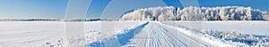 Winter landscape panorama with road and forest