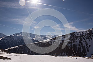 Winter landscape - Panorama of the ski resort with ski slopes and ski lifts with blue sky on background. Alps. Austria