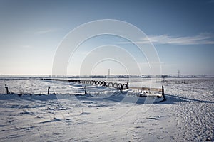 Winter landscape photo, Vintage iron wheel tractor in the snow