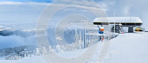 Winter landscape in the Polish mountains of the Sudetes, a ski lift on the Czarna Gora mountain, a thick layer of snow on the