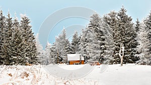 Winter landscape in the Polish mountains of the Sudetes, a snow-covered tourist shed on a mountain hiking trail