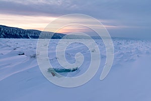 Winter landscape with ridged ice on the frozen river