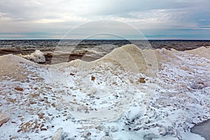 Winter landscape with a river covered with snow and ice hummocks. Ob River, Western Siberia