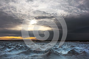 Winter landscape with a river covered with snow and ice hummocks. Ob River, Western Siberia