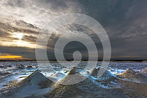 Winter landscape with a river covered with snow and ice hummocks. Ob River, Western Siberia