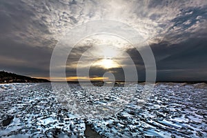 Winter landscape with a river covered with snow and ice hummocks. Ob River, Western Siberia