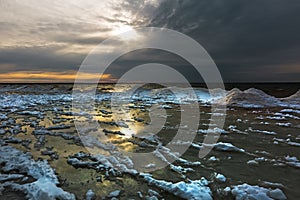 Winter landscape with a river covered with snow and ice hummocks. Ob River, Western Siberia