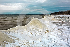 Winter landscape with a river covered with snow and ice hummocks. Western Siberia