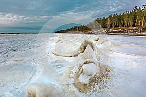 Winter landscape with a river covered with snow and ice hummocks. Western Siberia