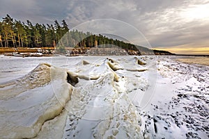 Winter landscape with a river covered with snow and ice hummocks. Western Siberia