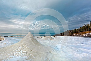 Winter landscape with a river covered with snow and ice hummocks. Western Siberia