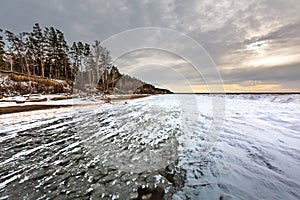 Winter landscape with a river covered with snow and ice hummocks. Western Siberia