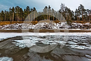 Winter landscape with a river covered with snow and ice hummocks. Western Siberia