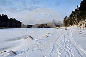 Winter landscape on the river. Fishermen catch fish in winter. Ice fishing.