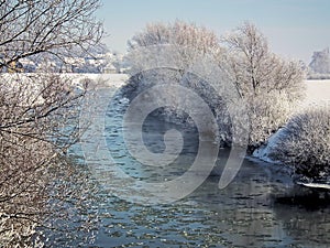 Winter landscape and river with flowing floes