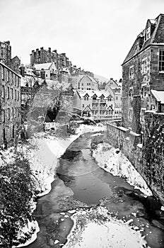 Winter Landscape with River Flowing between Rows of Houses