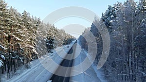 Winter landscape,road and snow covered trees. Aerial view of highway among the forest. Snowy tree branch in a view of