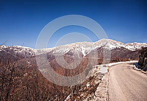 Winter landscape showing rocky mountain and road