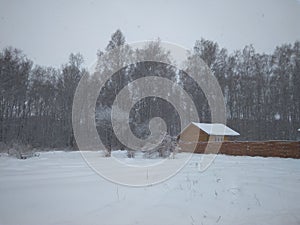 Winter landscape in Siberia wooden house in snow forest in snowdrifts