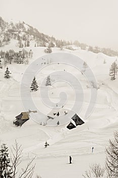 Winter landscape with a skier and a wooden hut