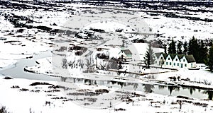 Winter landscape of small wooden church and houses at Thingvellir National Park, Iceland