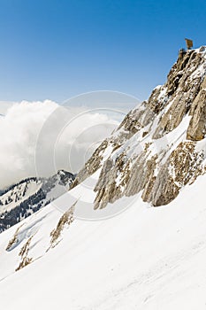 Vertical view on sunny day in the mountains. Winter landscape, snow blue sky and clouds in Mount Pilatus, Lucerne, Switzerland.