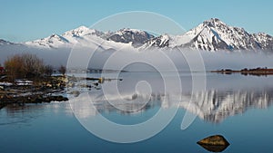 Winter landscape. Snow-capped mountains and a sea bay around. Beautiful nature. Norway. Lofoten islands. Scandinavia