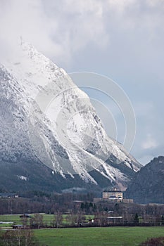 Winter landscape with snow covered Grimming mountain and Trautenfels Castle in the district of Liezen in Styria, Austria