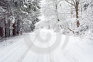 Winter landscape with snow-covered trees on the mountain road. Sudetes covered with white snow