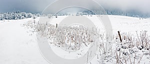 Winter landscape with snow-covered trees on the mountain road. Sudetes covered with white snow