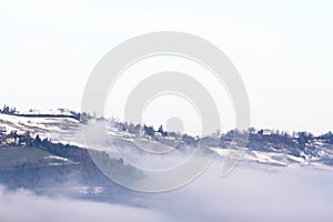 Winter landscape with snow and fog in the Tosco Emiliano Apennines, Bologna, Italy