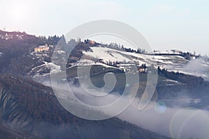 Winter landscape with snow and fog in the Tosco Emiliano Apennines, Bologna, Italy photo