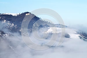 Winter landscape with snow and fog in the Tosco Emiliano Apennines, Bologna, Italy