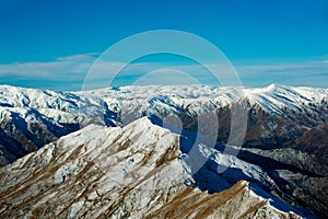 Winter landscape of snow mountain against blue sky in South island, New Zealand