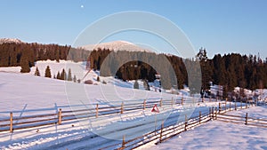 Winter Landscape with snow on road and moon during sunset. Christmas time