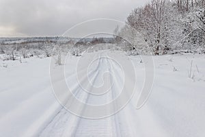 Winter landscape with snow road and snow-covered trees. Winter nature background
