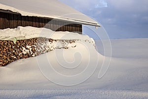 Winter landscape with snowcapped wooden hut