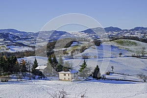 Winter landscape. Snowy hills, homes, nature, horizon. Natural background. Appennino-Tosco-emiliano photo