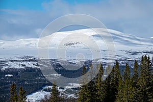 Winter landscape with snowy mountains in the background photo