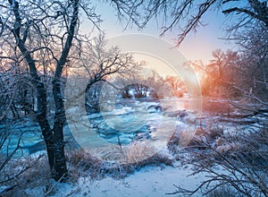 Winter landscape with snowy trees, ice, beautiful frozen river