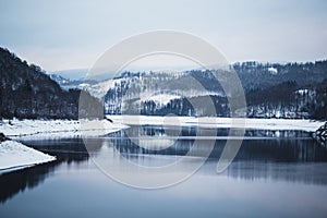 Winter landscape at Soesetalsperre in Harz Mountains National Park, Germany. Moody snow scenery in Germany