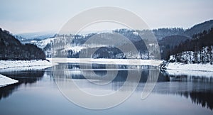 Winter landscape at Soesetalsperre in Harz Mountains National Park, Germany. Moody snow scenery in Germany