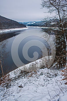 Winter landscape at Soesetalsperre in Harz Mountains National Park, Germany. Moody snow scenery in Germany