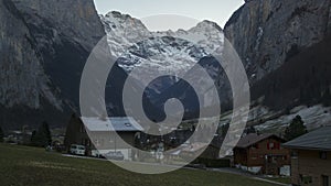 Winter landscape stunning touristic town with high cliffs in background,Lauterbrunnen.